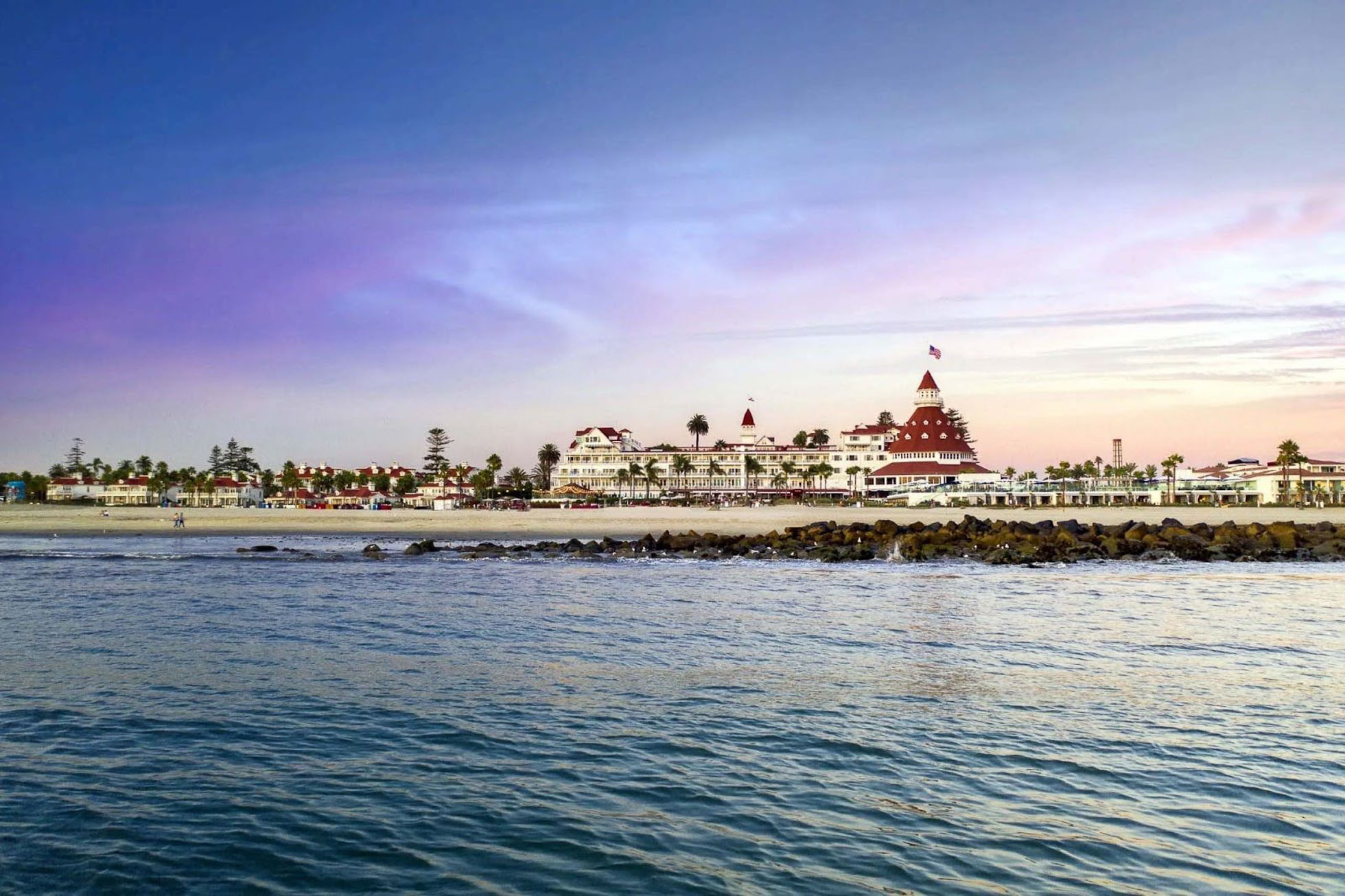 Iconic San Diego beachfront hotel captured at sunset, a picturesque location for beach weddings and bridal beauty services.